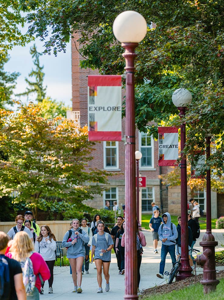 Students walking through the IUP Oak Grove during a class change
