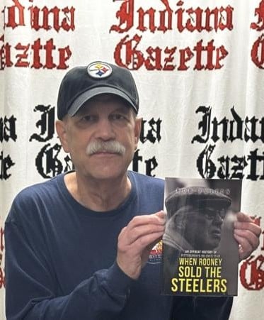 Bob Fulton holding his book