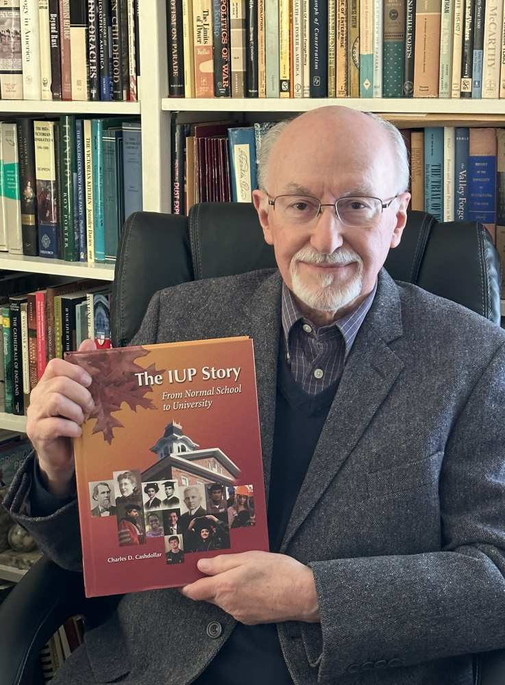 Charles Cashdollar holding his book