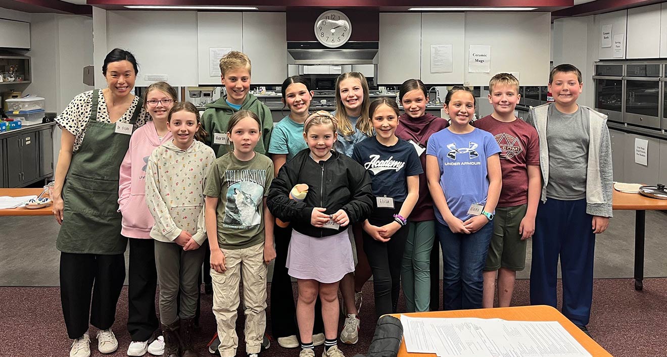 Group photo of Pao Ying Hsiao with her 12 students in IUP's Teaching Kitchen.