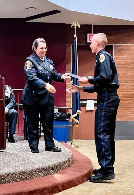 Marcia Cole, director of the IUP Criminal Justice Training Center, on stage, congratulating the cadets who received the Quest for the Best scholarship