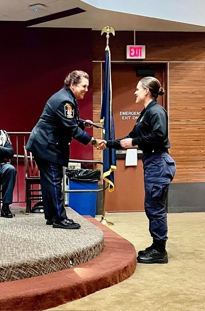 Marcia Cole, director of the IUP Criminal Justice Training Center, on stage congratulating the cadets who received the Quest for the Best scholarship