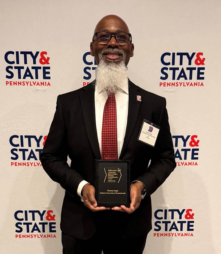 Thomas Segar with his recognition plaque