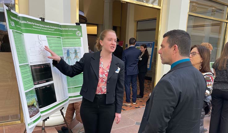 Serena Aumick discussing her research with Rep. Jim Struzzi