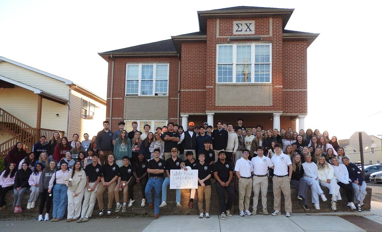 IUP fraternity and sorority members in front of the Sigma Chi fraternity house