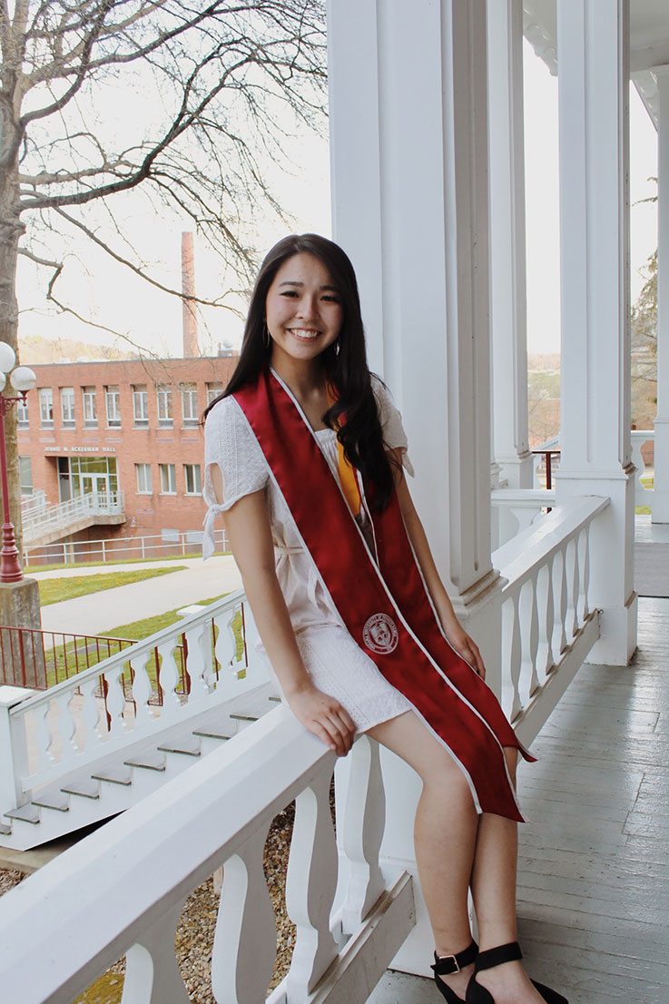 Teresa Kuo on the porch of Sutton Hall