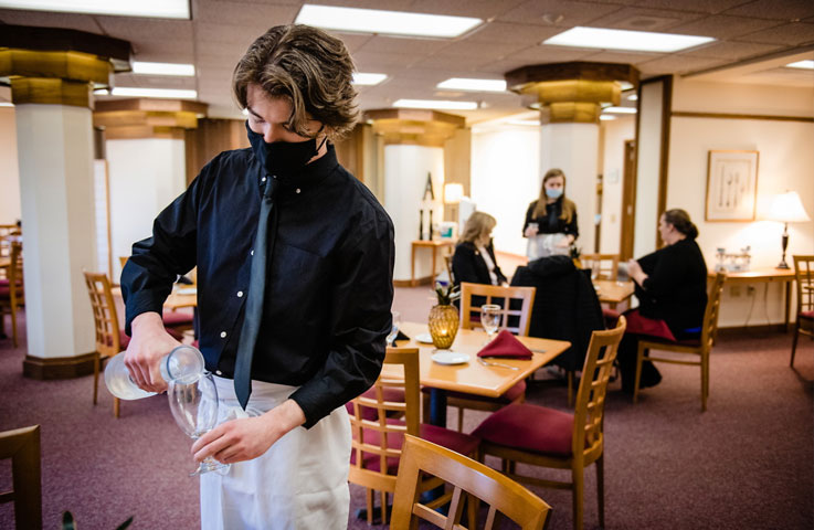 Tristen Ring, a junior, worked in the dining room during lunch at the Allenwood in March.