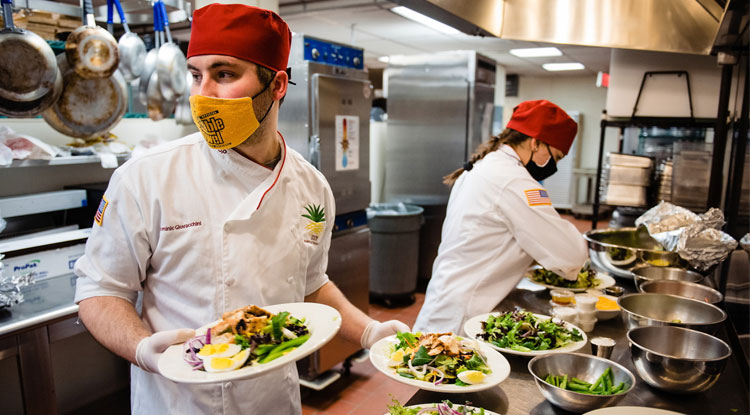 Dominic Giovacchini, a senior, and Heidi Neumann, a junior, prepared lunches at the Allenwood in March.