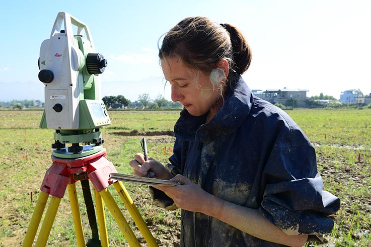 Andrea Palmiotto taking notes at an archaeological work site  