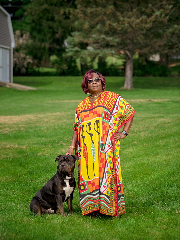 Carol Asamoah with her dog, Hollow, outside her White Township home
