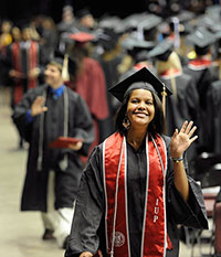 A new graduate waves to the crowd during the May 2011 commencement ceremony.