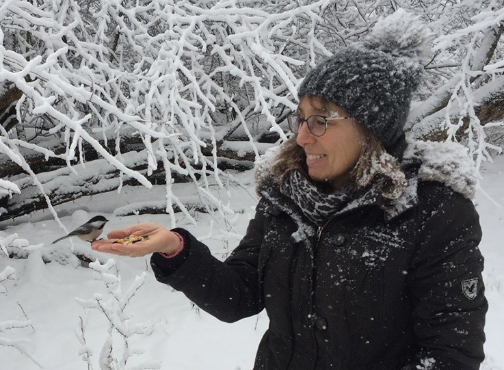 Ellen Yerger holding a chickadee 