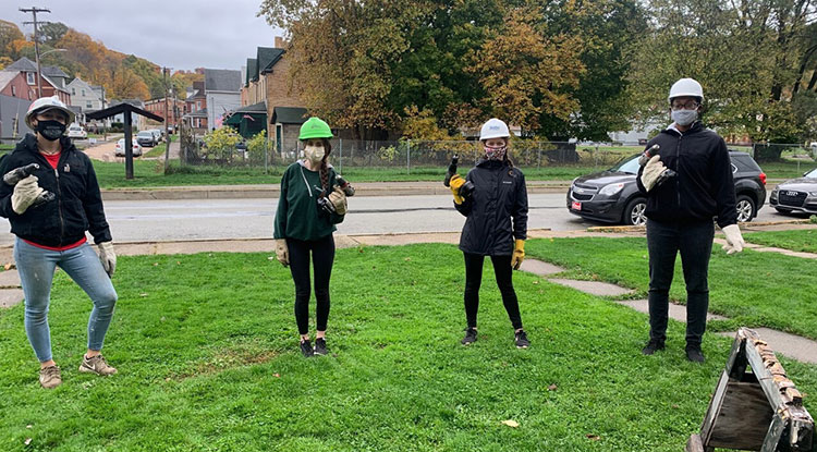 Members of IUP's student chapter of Habitat for Humanity stood at the ready at a work site. Members of IUP's student chapter of Habitat for Humanity stood at the ready at a work site.
