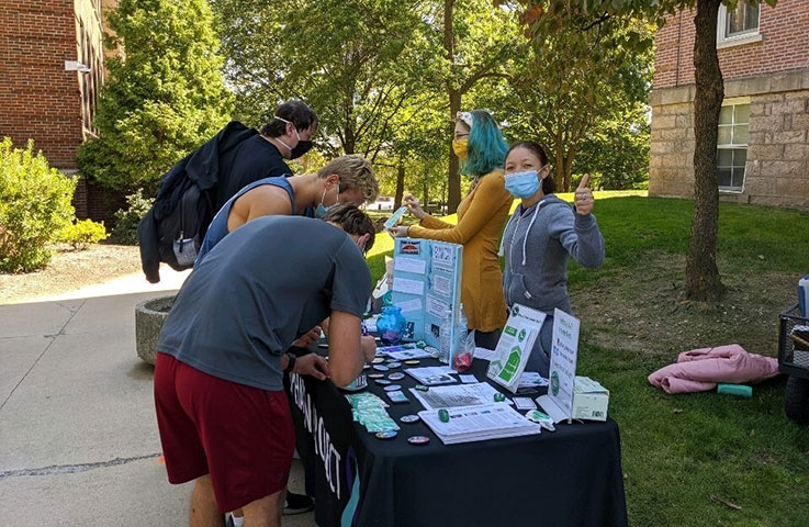Haven Project members providing information and resources at a table in the Oak Grove during RAINN Day Haven Project members providing information and resources at a table in the Oak Grove during RAINN Day