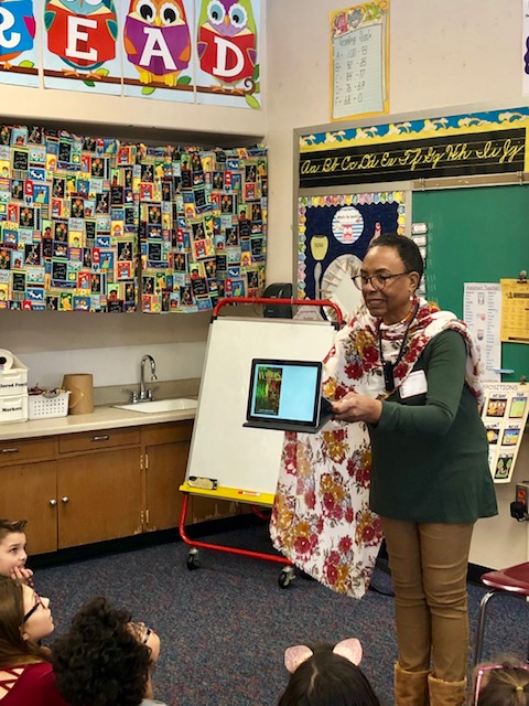 Janet Guyden reads to elementary student during Read Across America