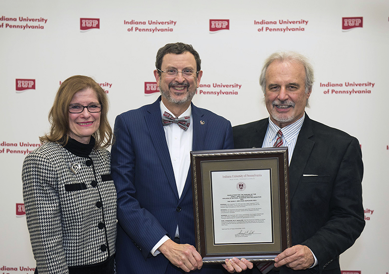 John and Char Kopchick and President Driscoll with the resolution to name the new Natural Sciences and Math building after the Kopchicks 