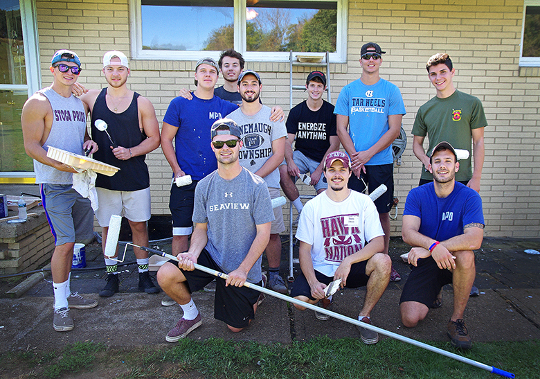 Members of the Military Philanthropy Organization helping a family at their home