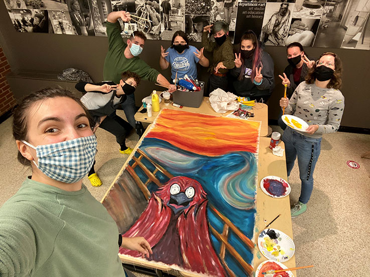 National Art Education Association members beside their nearly complete Homecoming 2020 banner. From left: Brianna Adkins, Jen Freno, Davey Beyer, Juliana Shaffer, Mackenzie Brudnock, Faith Hoffman, Iris Kauffman, and Mary Crouse.