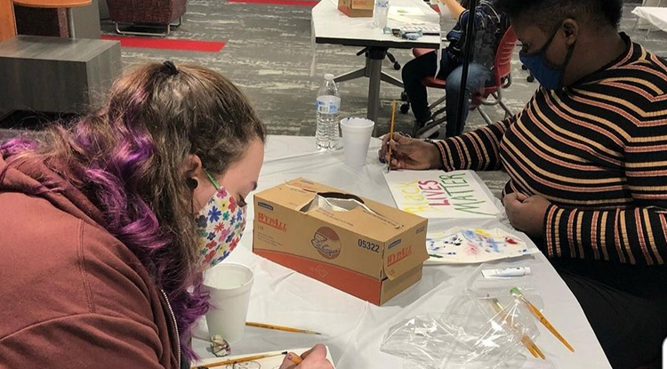 Gabriella Dalverny, left, and Sequoia Stauffer during a paint night with members of Queer Colors and the Black Student League.