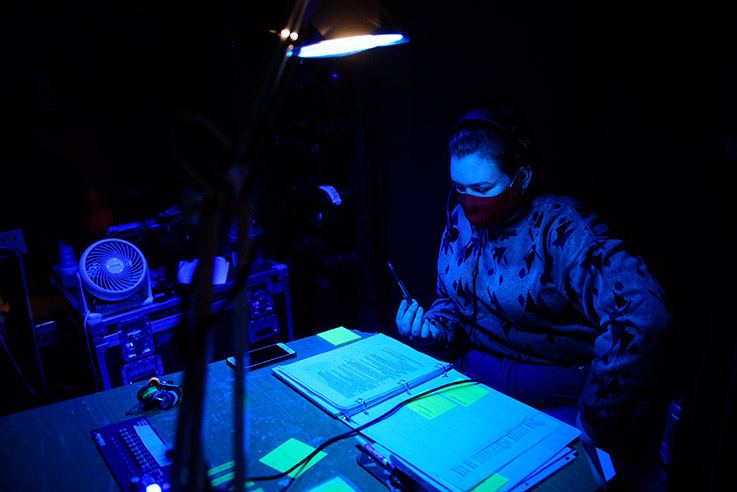 Abby McCoy, a senior theater major with a communications media minor, stage manages the production, calling light and sound cues from the control booth in Waller Hall.