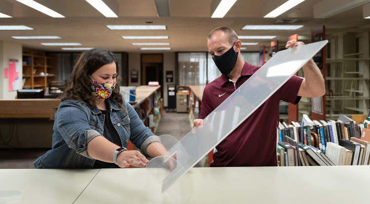 At North Dining, window decals guide students on where to enter and exit to maintain a safe distance from others. 