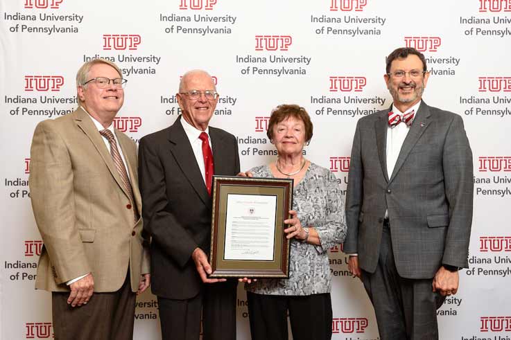 IUP Trustee Tim Cejka, at left, presents Harold (Hal) and Elizabeth (Betty) Wingard