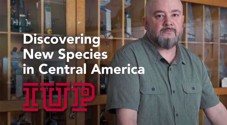 Josiah Townsend standing in front f a shelf of microscopes with the text Discovering New Species in Central America overtop