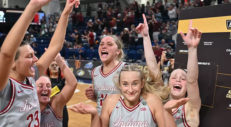members of the womens basketball celebrating on court after their win