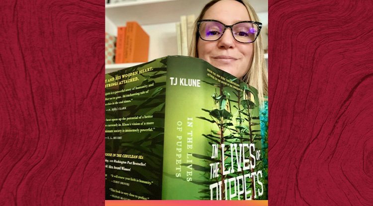 Headshot of Erika Frenzel looking at camera over an open book