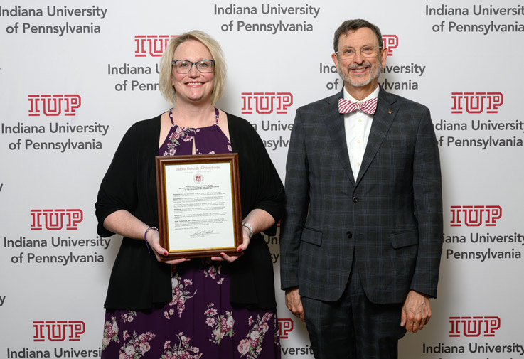at left, Interim Dean of the College of Health and Human Services Lynanne Black, who accepted the resolution on behalf of Meredith Light, with IUP President Michael Driscoll.