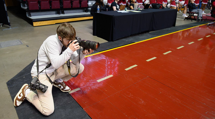 Cameron Horning photographing a basketball game