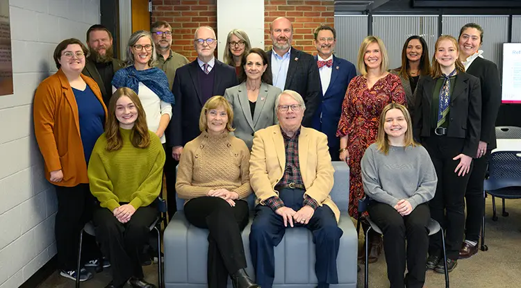 Group of Indiana University of Pennsylvania students, faculty, and donors standing together and smiling at a campus event.