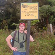 Jeff Larkin standing outside next to a sign