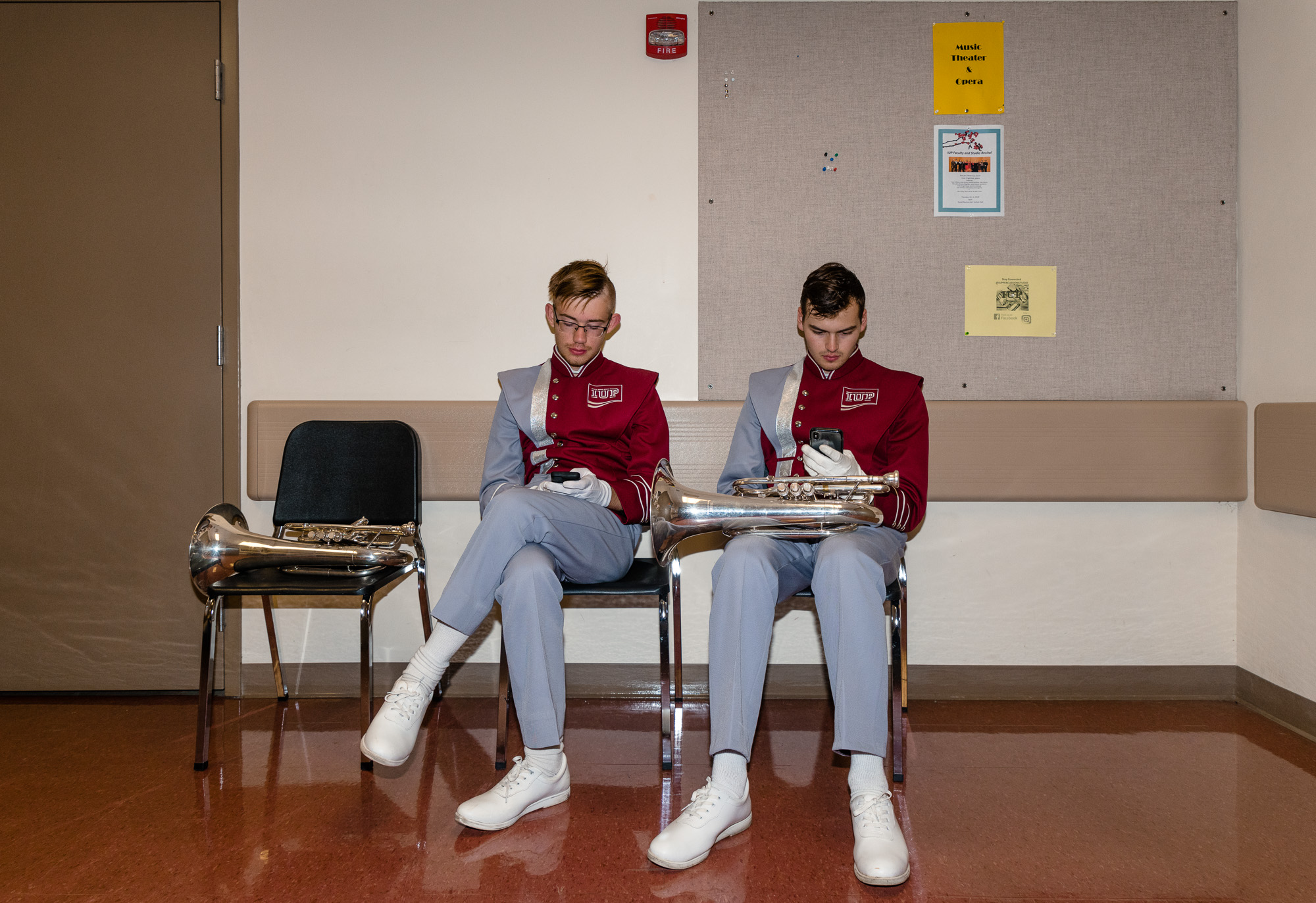 Members of the IUP marching band look at their personal electronic devices during their break.