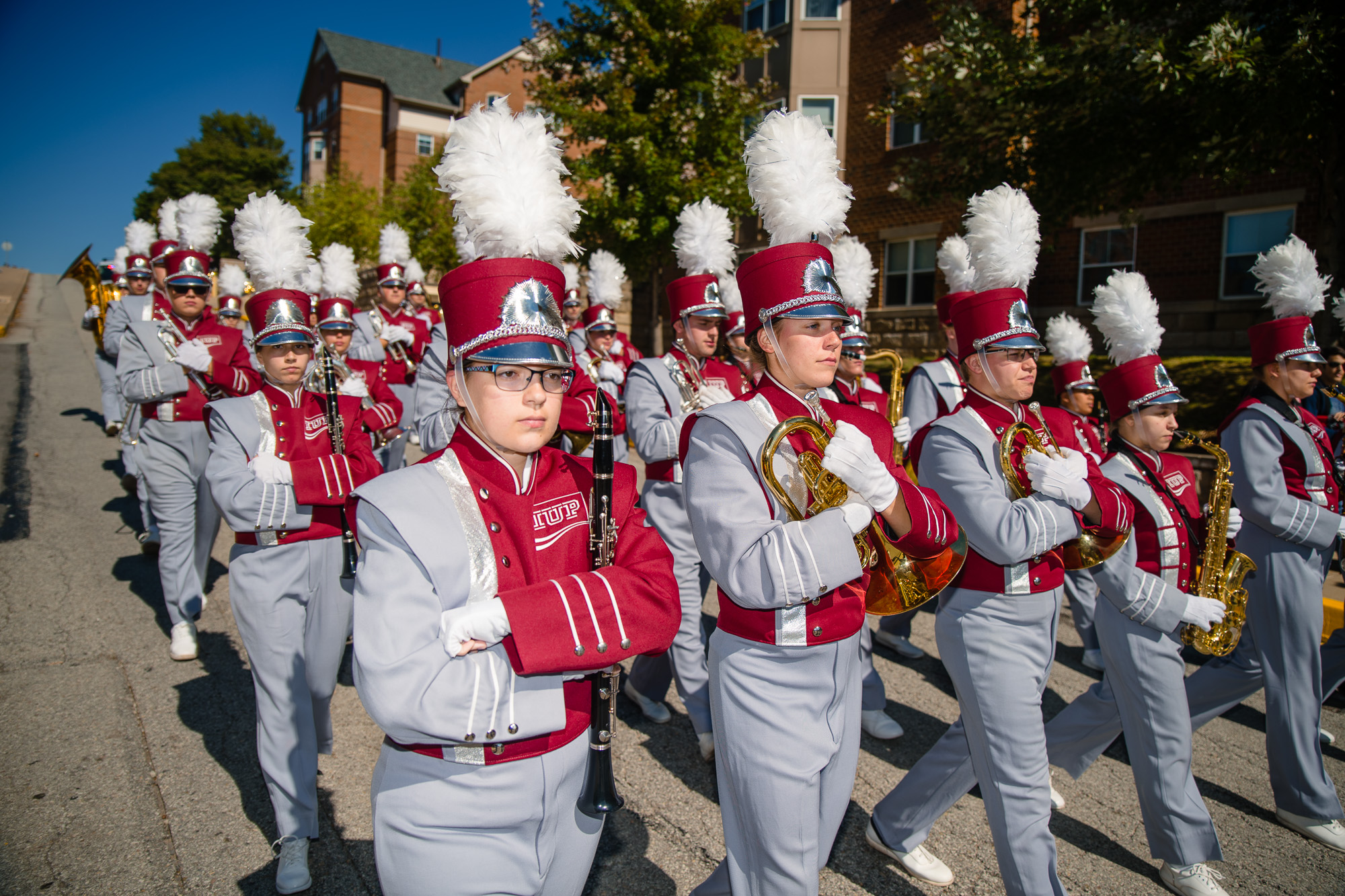 The IUP marching band marches toward the George P. Miller Stadium, where the IUP Crimson Hawks will take on California in the annual Coal Bowl.
