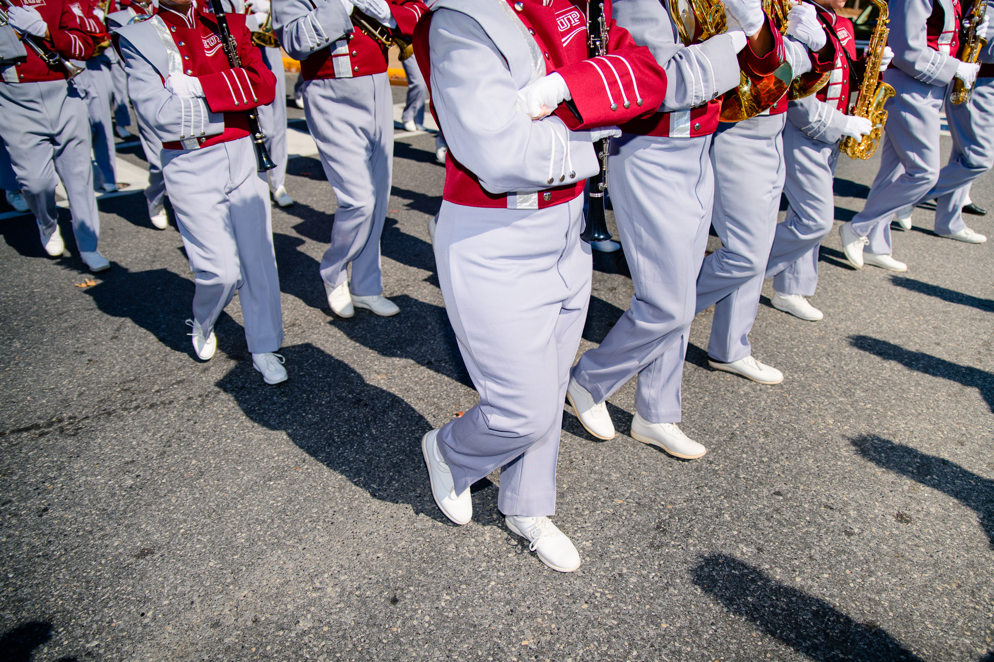 The band marches down the street through IUP's campus.
