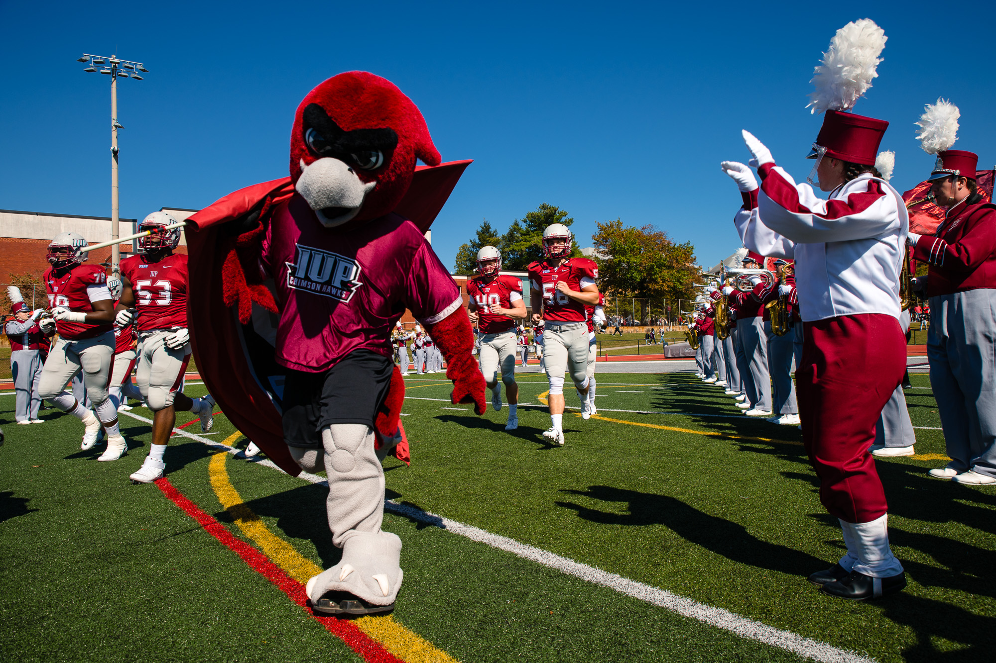 The IUP mascot, Norm, leads the football team out onto the field before the start of the game against Cal U.