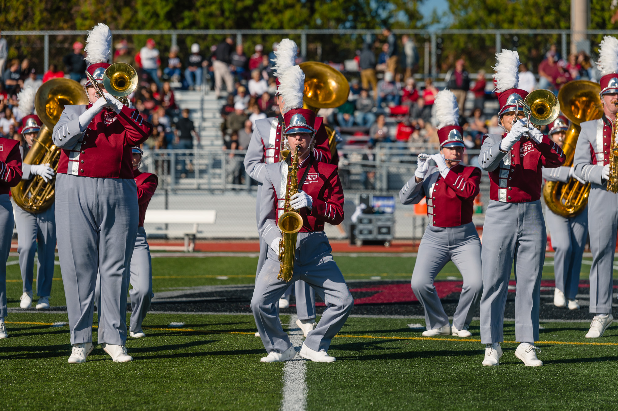 The band performs on the football field during halftime.