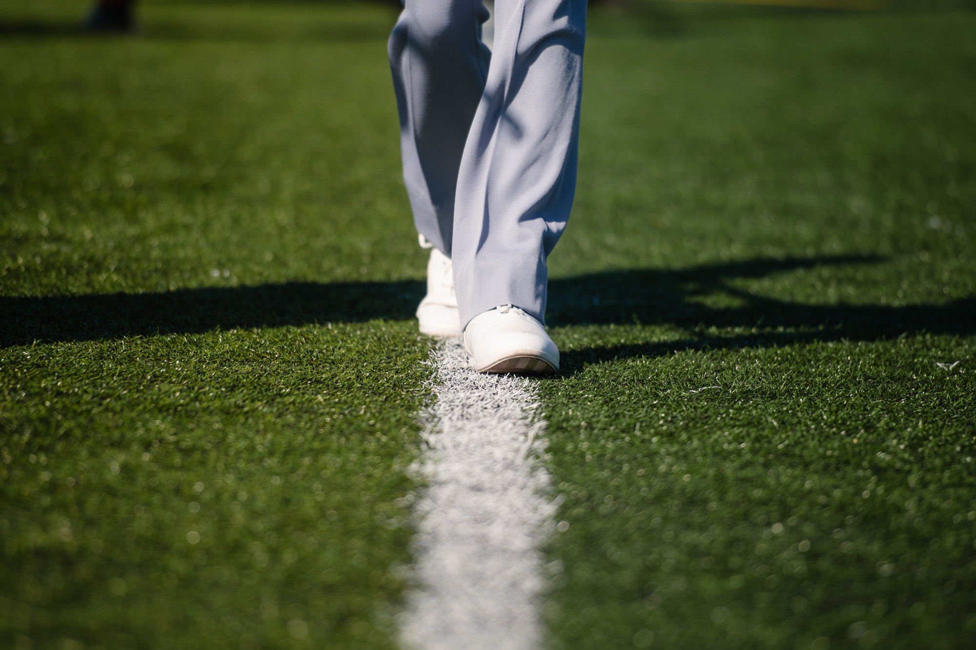 A member of the band walks along the 50-yard line during their halftime show.