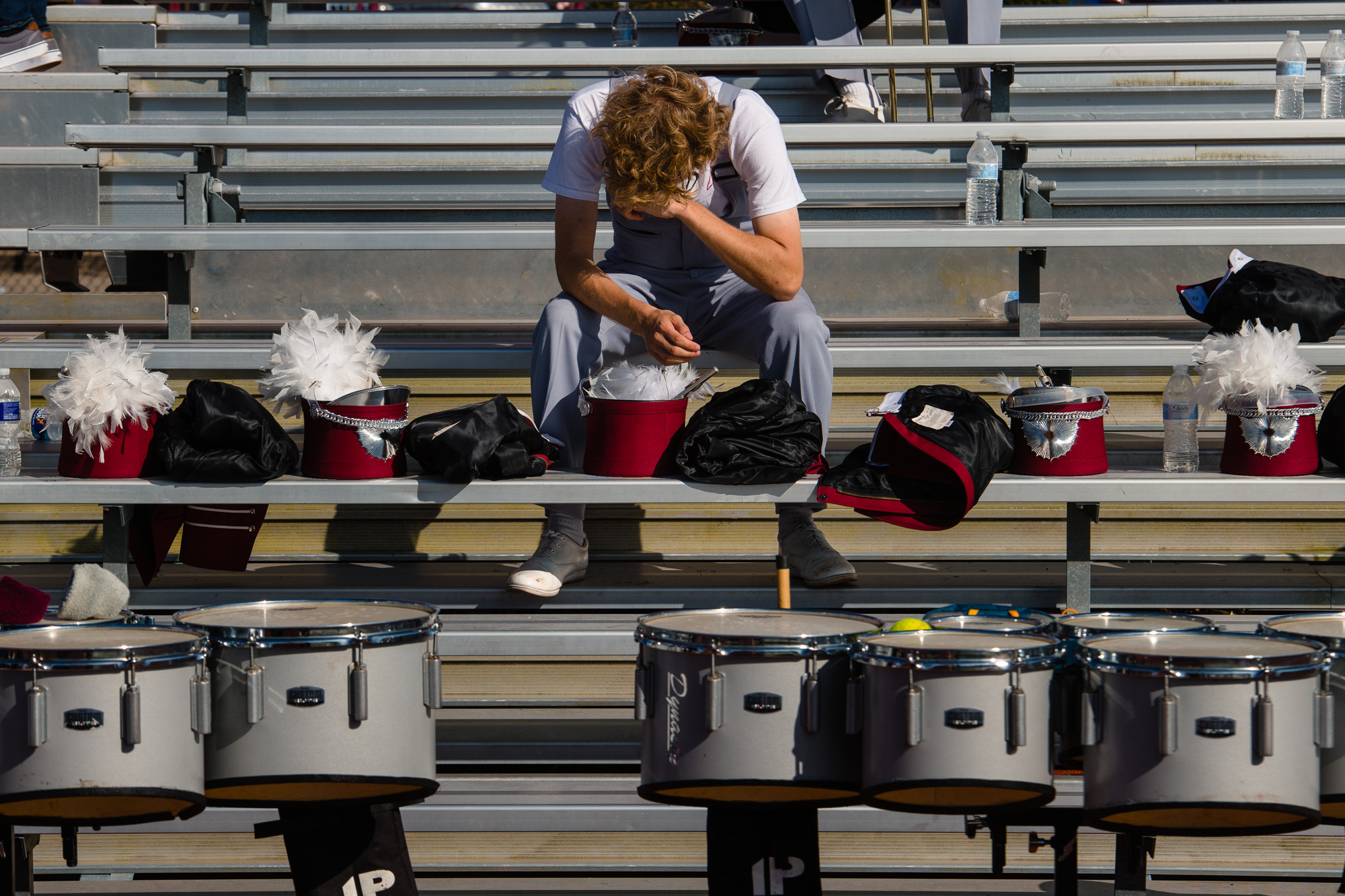 A member of the IUP marching band rests after the band’s halftime performance.