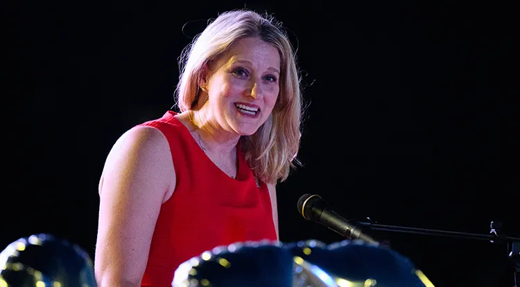 Laurie Kuzneski speaking at a podium