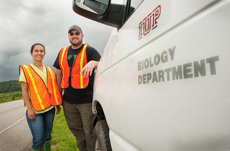 Cassandra Krul, left, and Ian Forte stand next to an IUP Biology Department white van parked roadside near the Flight 93 memorial.