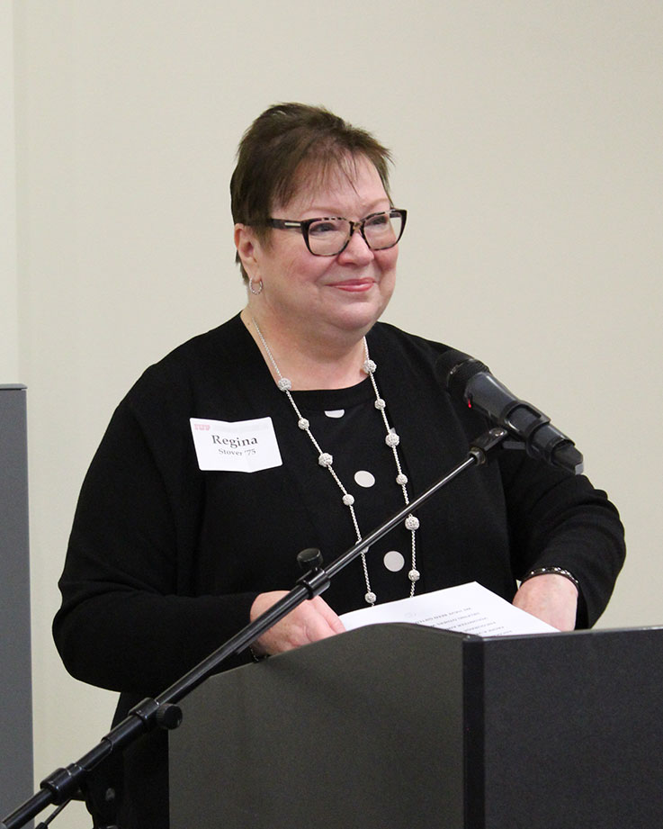 Regina Stover speaking at the podium