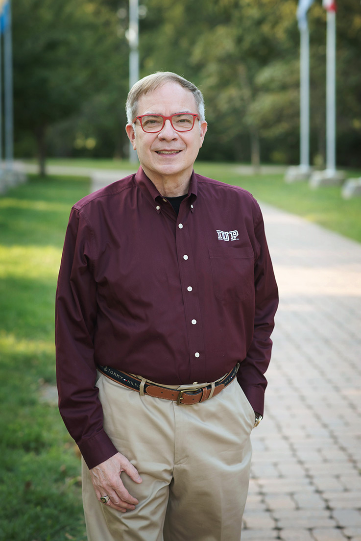 Portrait of Stephen Abel on a walkway surrounded by grass