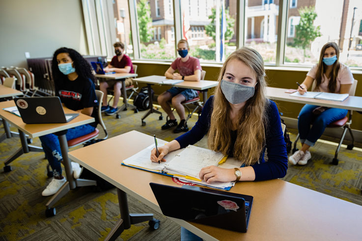 students in a classroom wearing masks