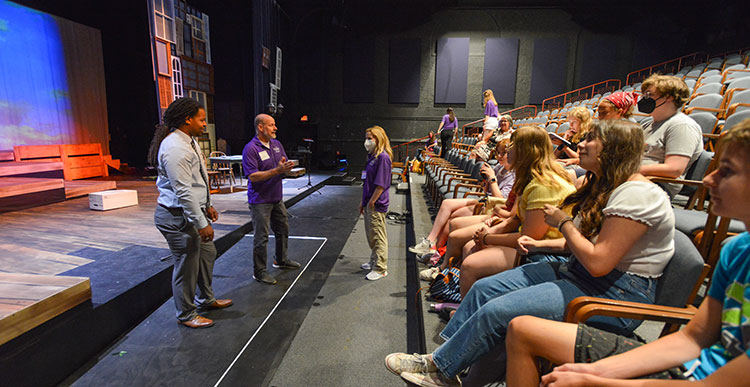 Eli Downie, left, learning about the Footlight Players theater-for-youth program from Brian Jones, executive director, and Sharen Camille, artistic/musical director, in Waller Hall.