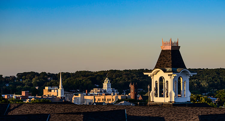A view of the rooftops of downtown Indiana from the roof of Sutton Hall with the bell tower in the foreground