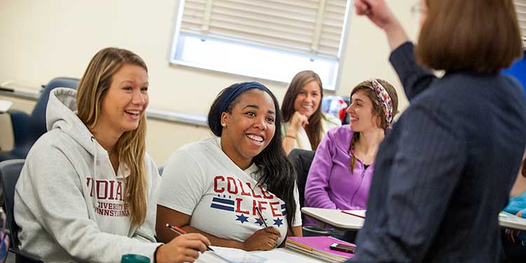 Students listening to a professor in the classroom