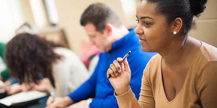 Students taking notes in a Counseling class