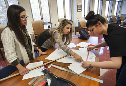 Fashion merchandising students work together on a project